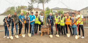 Group with shovels plant trees