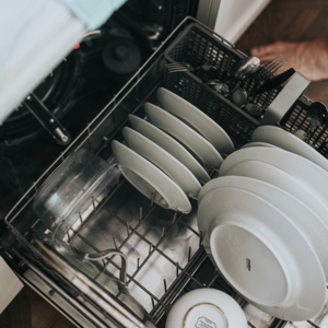 Overhead view of white dishes in dishwasher