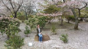 Elise sitting on rock in Japan